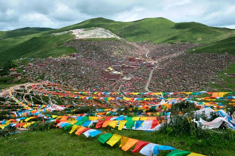 Thousands of tiny homes sprawl up a mountainside forming one of the world's largest Buddhist Institutes.