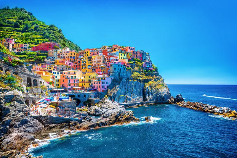 Cinque Terre is actually a string of five old seaside villages on the rugged Italian Riviera coastline. All of the 5 little towns are blazing with color.