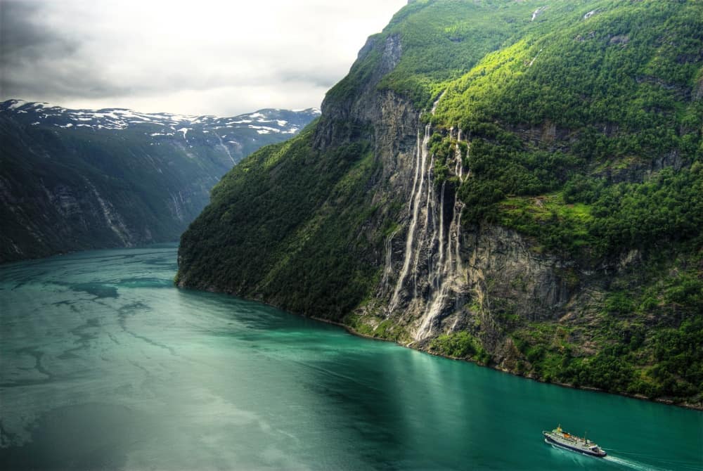 There are two old farms on both banks of the fiord, you can actually see one of them on the right side of the sisters in this photo. Seven Sisters Waterfall. Photo by Seven-Sisters-Waterfall